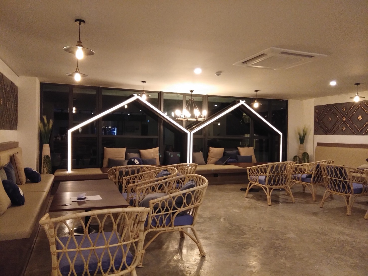 Kokotel lounge with illuminated house-frame feature at night