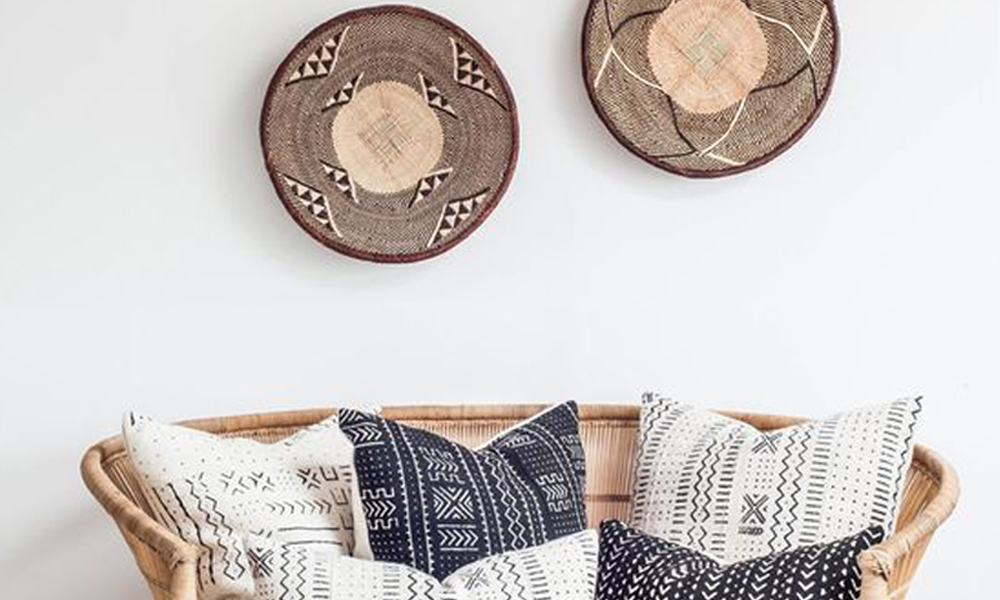 Woven wall baskets and patterned pillows reference