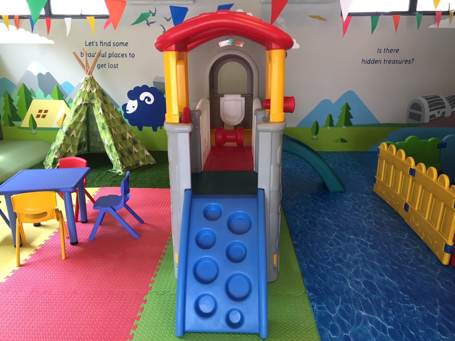 Playhouse with slide and camping teepee mural