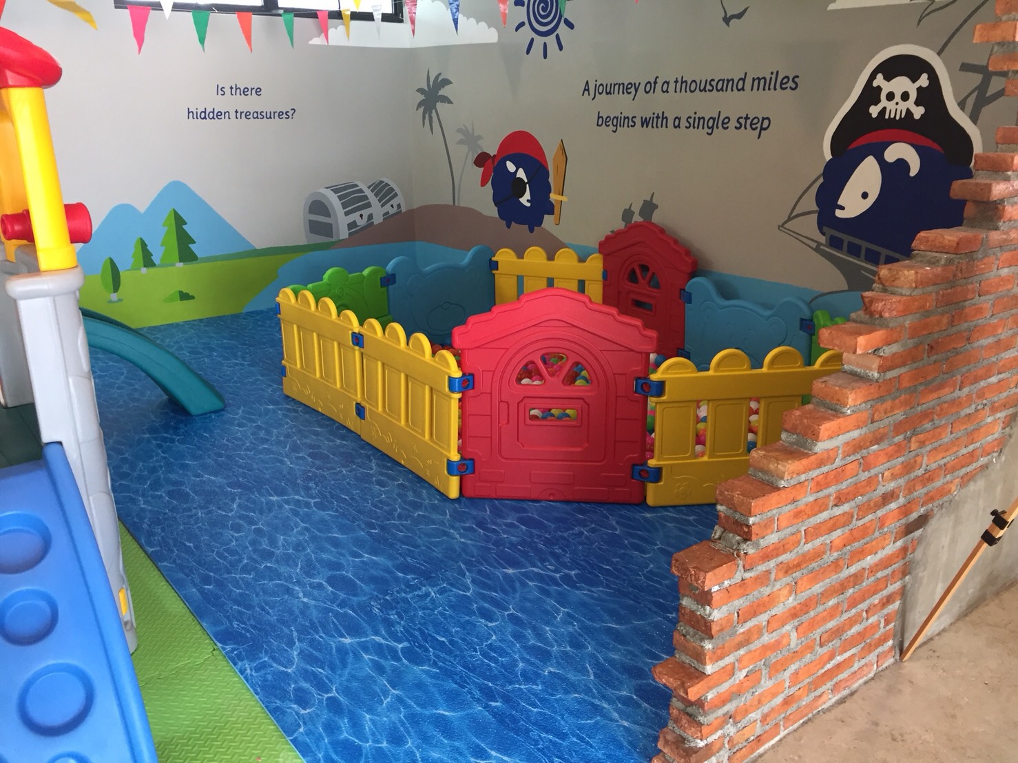 Pirate-themed ball pit corner with brick wall